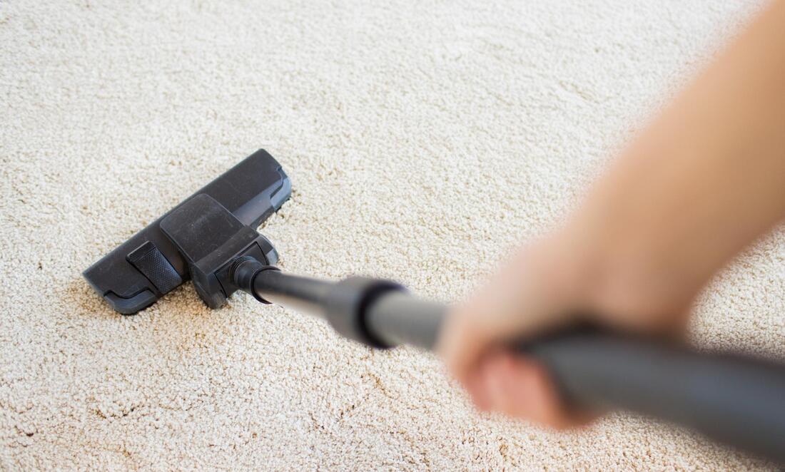 carpet being clean by the use of vacuum 