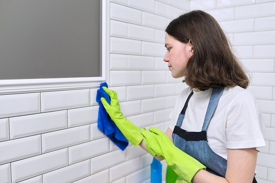  a young lady grouting the tiles